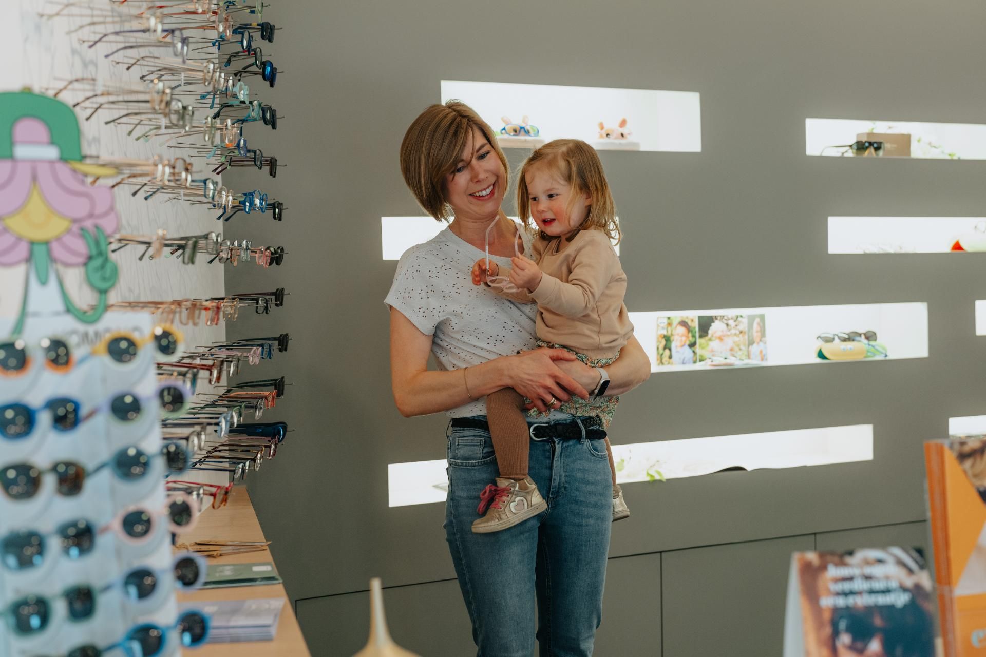 Twee kinderen poseren met hun nieuwe bril van Optiek Ploem